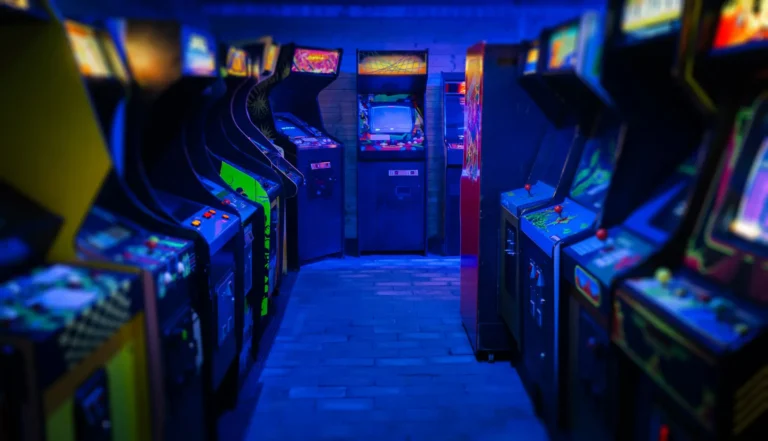 A dimly lit aisle of arcade machines