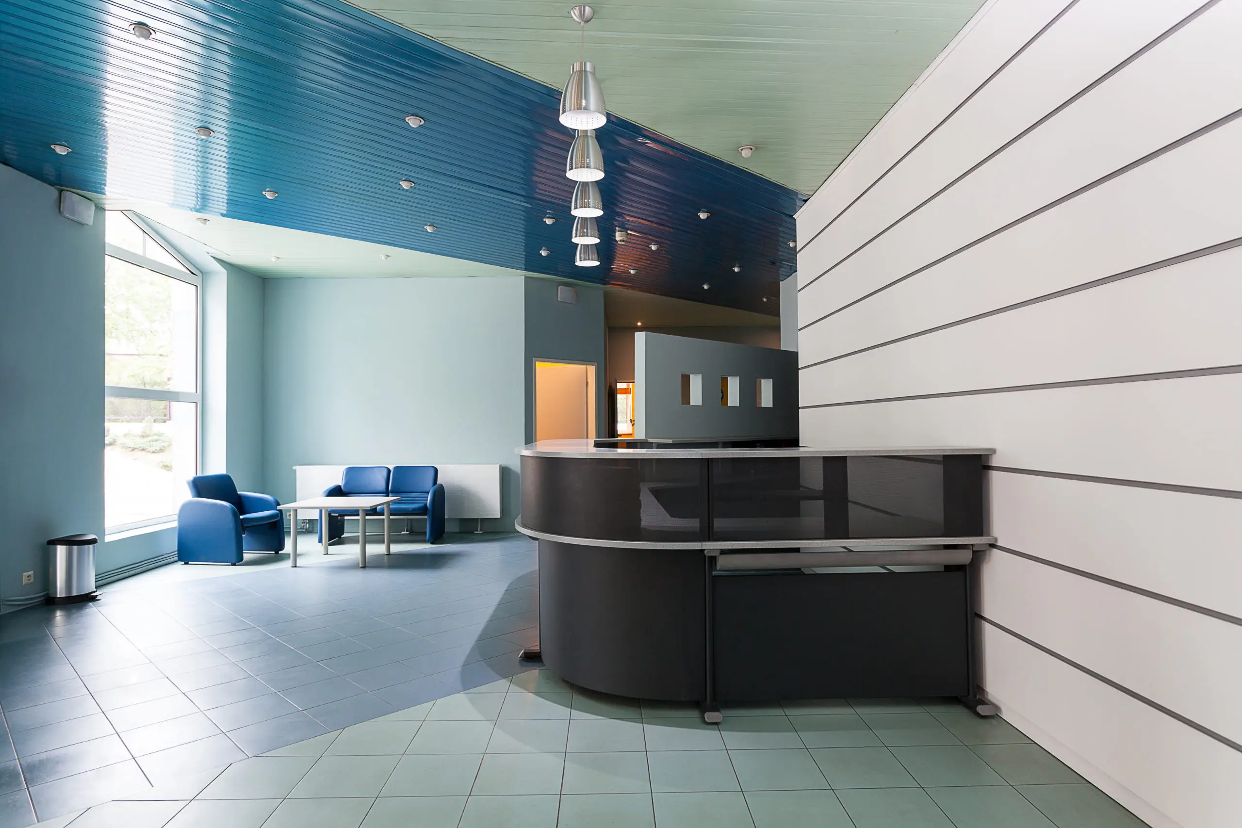 A clean, well-lit modern bank lobby and waiting area with fresh paint
